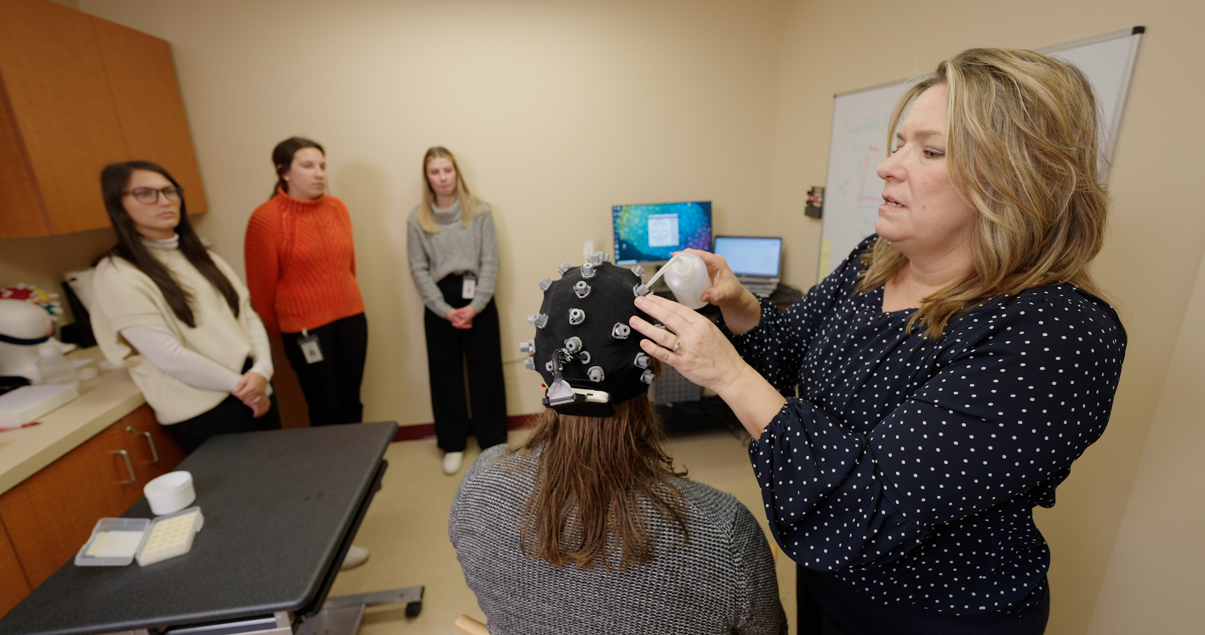 Sharyl Samargia-Grivette in her lab with students demonstrating neuro research