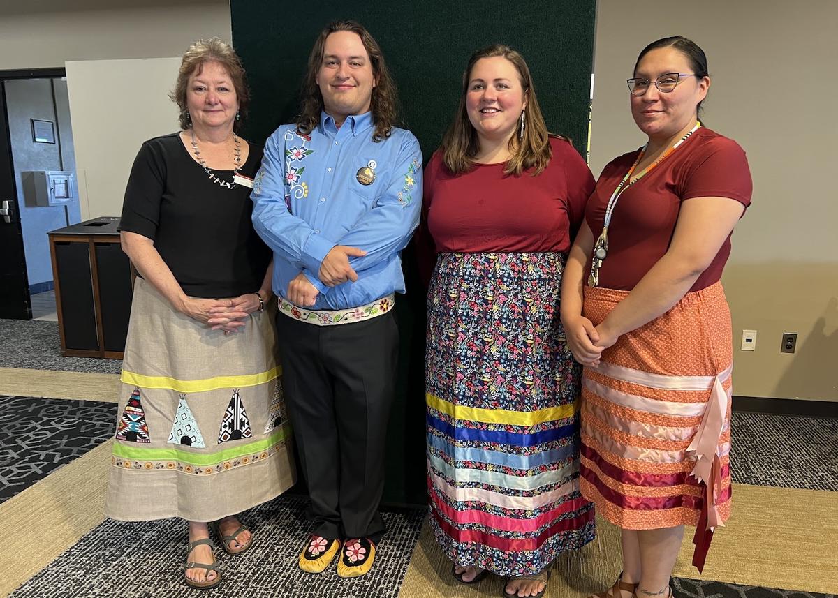 Jody O'Connor, James (Ozaawaanakwad) Clark, Brooke Lunski, and Iris Carufel pose after American Indian Learning Resource Center Fall Feast 2023.