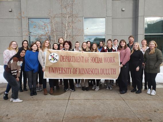 BSW and MSW students hold up a banner that reads "Department of Social work University of minesota Duluth 