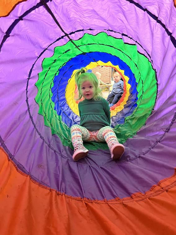 Toddle making her way through a rainbow tunnel 