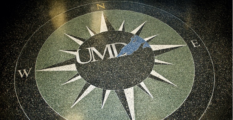 Compass rose with UMD logo at the center