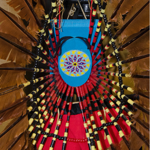 blue beaded center of a brown feathered headdress