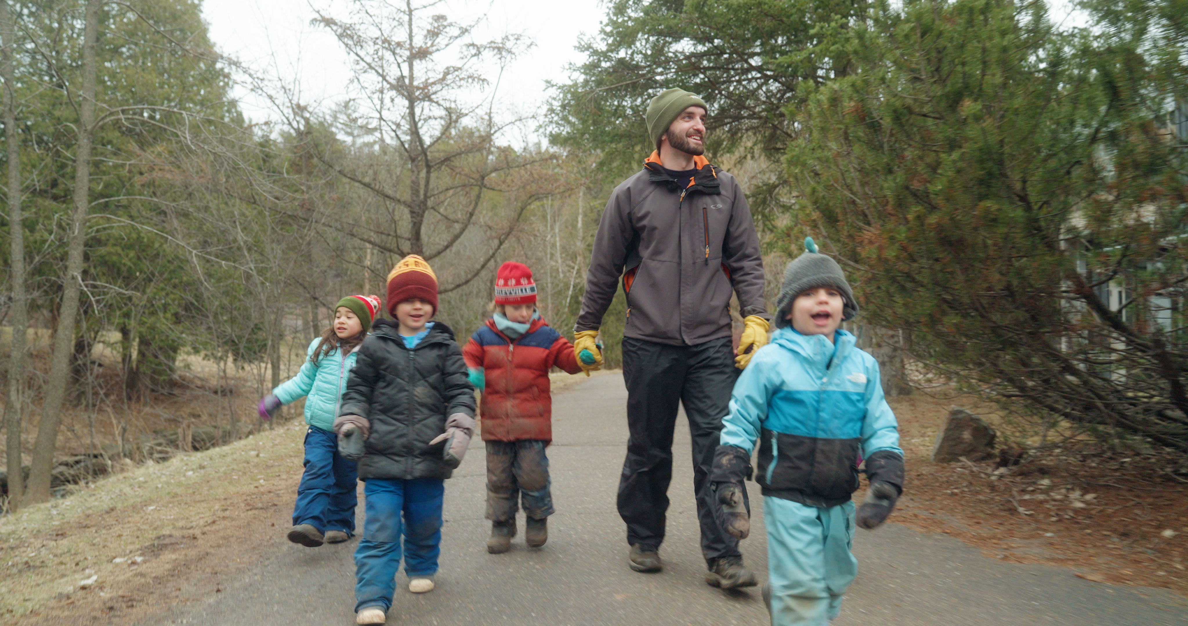 children walking with a graduate student of childhood nature studies