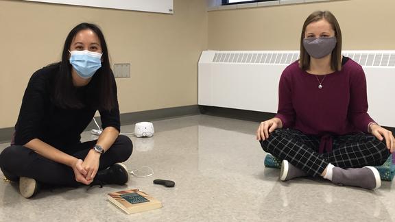 2 UMD students practicing yoga in the department of Psychology