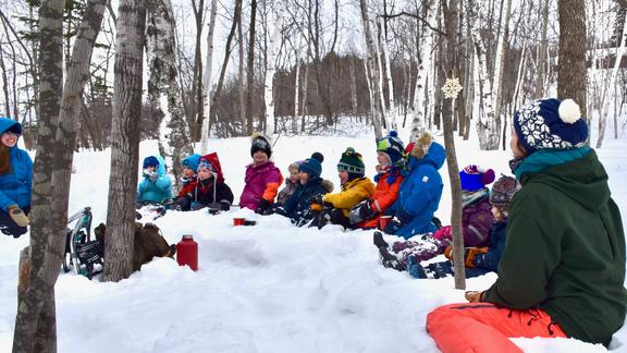Windridge preschoolers with teachers enjoying tea outside in the snow