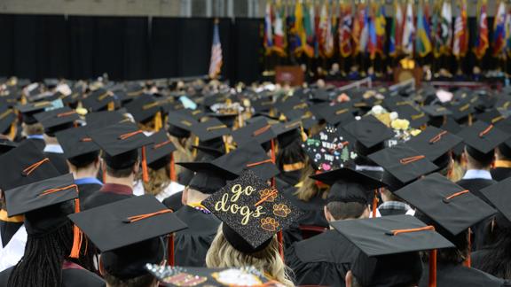 A photo of graduating UMD students with their caps and gowns on