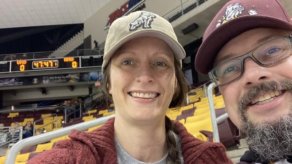 Meredith Schneider and her husband at a bulldog hockey game