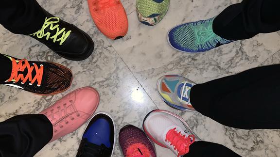 people with bright neon shoes in a circle