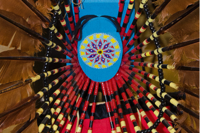 blue beaded center of a brown feathered headdress