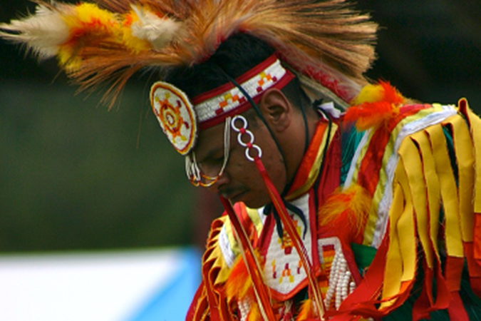 Dancing American Indian dressed in traditional garb