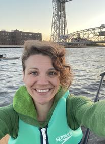 Laura Brandt smiling for a photo in Duluth behind the lift bridge