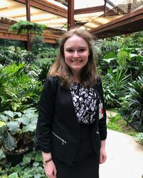 Bethany Westerberg stands in a greenhouse smiling for a photo.