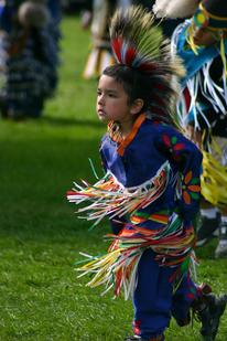 American Indian child dancing at a pow wow