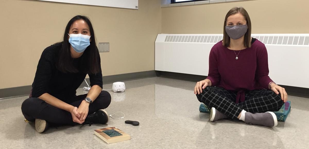 2 UMD students practicing yoga in the department of Psychology