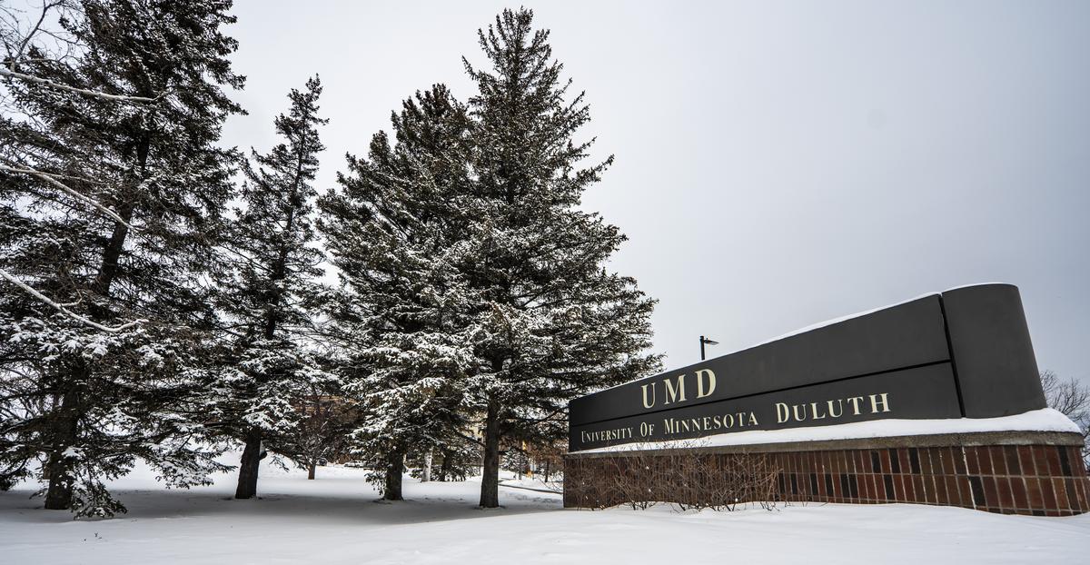UMD sign in winter with snow and trees