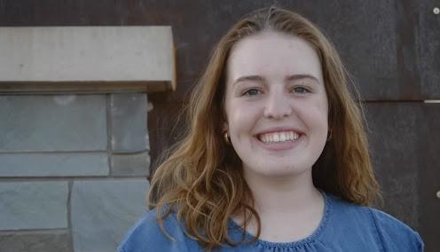 Gavrielle Gunther, a UMD student smiling in front of a brick building