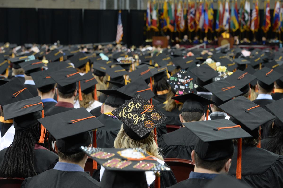A photo of graduating UMD students with their caps and gowns on