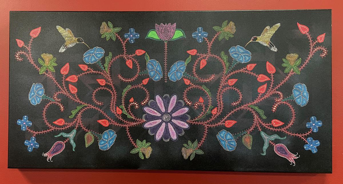 American Indian dot-style painting with black background and colorful flowers and hummingbirds