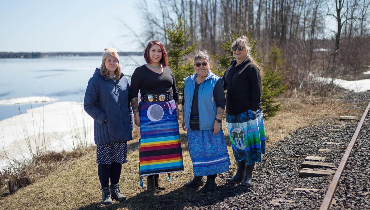 Members of the Indigenous Women's Water Sisterhood post near the site of the classroom with Sharon Day