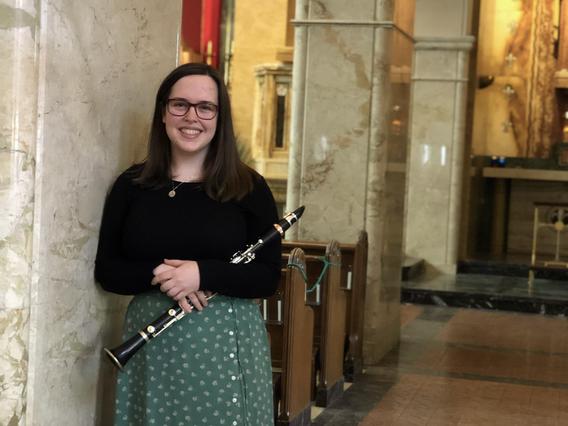Gabriella Emme smiling, holding a clarinet