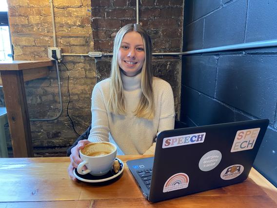 haley evans, a student at umd smiling for a photo at a coffee shop