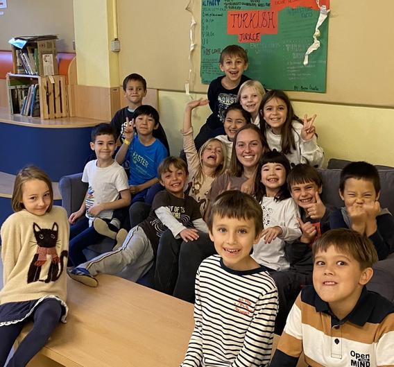 Children in a classroom in Slovenia along with their UMD student teacher