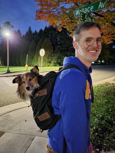 Pete Butz with dog in backpack