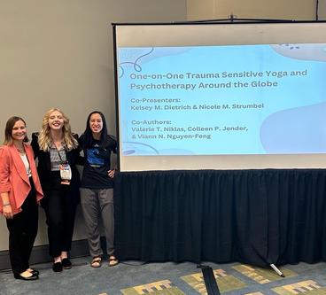 Nicole is pictured  (center) at a research presentation at an American Psychology Association convention along with graduate student Kelsey Dietrich and Assistant Professor Viann Nguyen-Feng. 